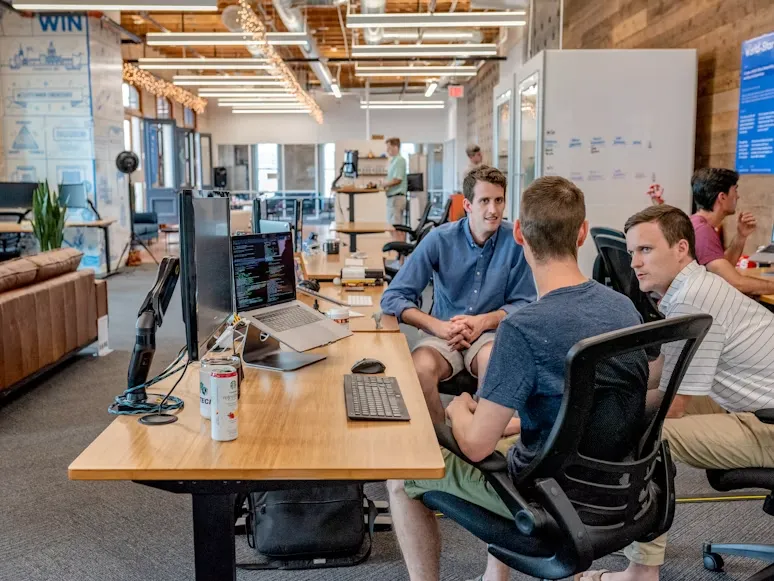 DreamerCoder team discussing a digital project with a client